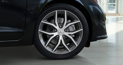 Close-up of a modern Acura's alloy wheel with a silver spokes design.