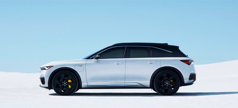 A sleek silver CPO Acura SUV with black accents parked on a snowy backdrop, showcasing its modern design.