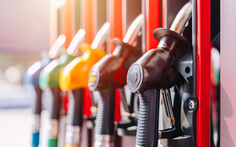 Close-up of colorful fuel pump nozzles in a gas station.