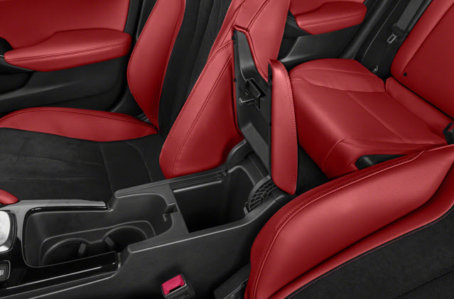 Close-up of a 2025 Acura Integra interior showing red leather seats and a center console.